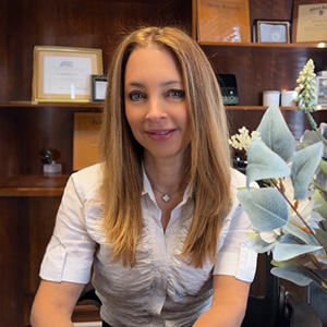 Meredith Scharf, Au.D., Doctor of Audiology at Manhattan Audio, smiling in the office.